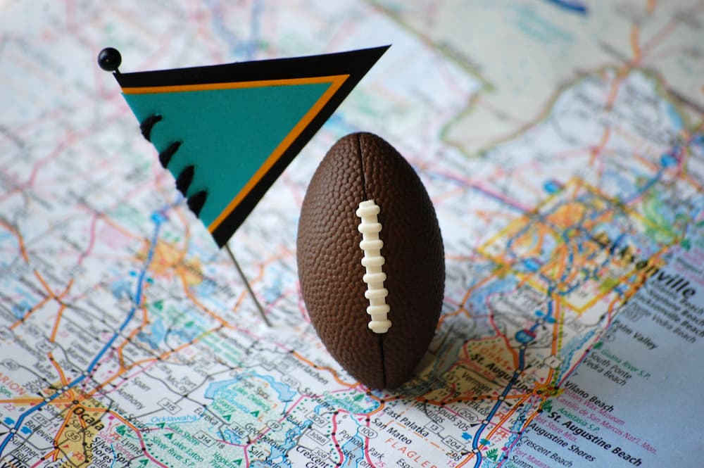 Mini football on a map with a mini Jacksonville Jaguars flag